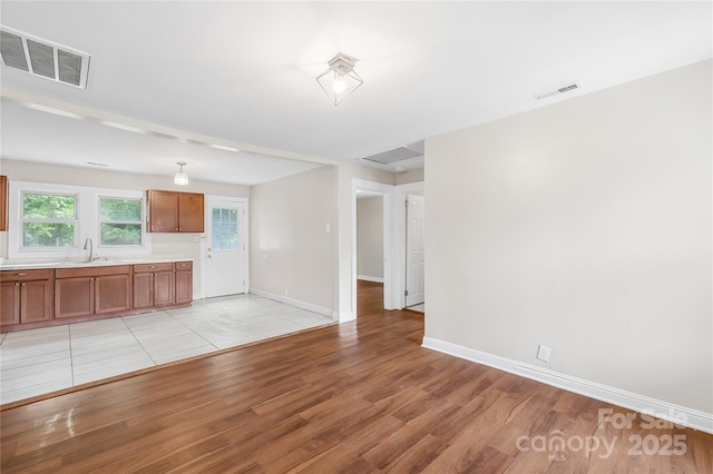 716 Wilson Rd, Salisbury, NC 28144 - unfurnished living room with light wood-type flooring and baseboards