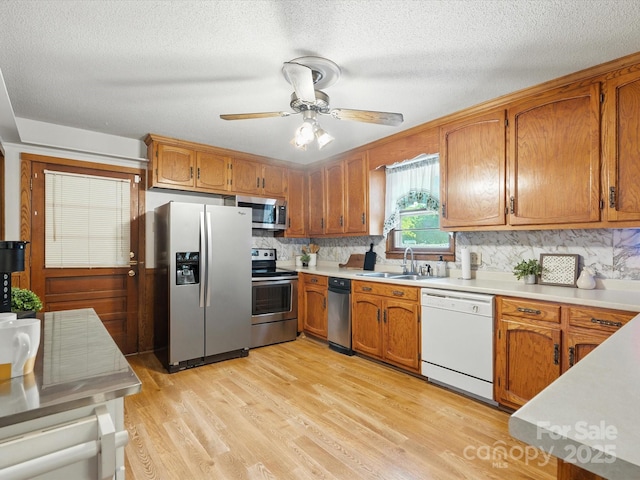 2212 Jb Denton Rd, Lancaster, SC 29720 - kitchen with stainless steel appliances, brown cabinets, and a textured ceiling