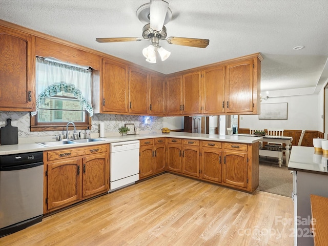 2212 Jb Denton Rd, Lancaster, SC 29720 - kitchen featuring white dishwasher, light wood finished floors, light countertops, brown cabinets, and a textured ceiling