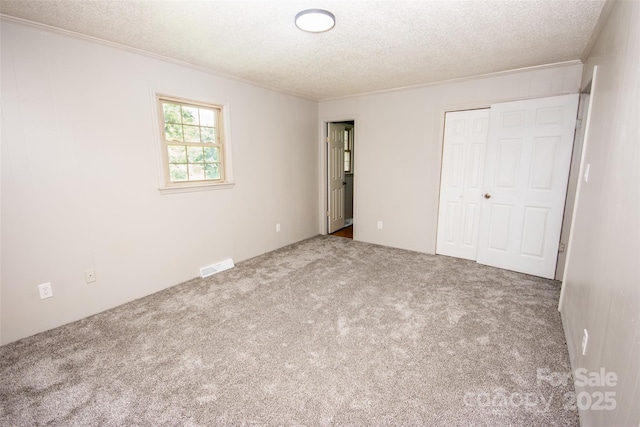 224 Mountain View Rd, Statesville, NC 28625 - unfurnished bedroom featuring a textured ceiling, carpet floors, crown molding, and a closet