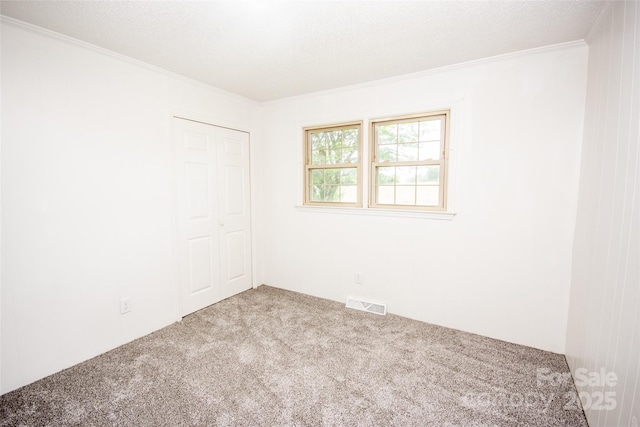 224 Mountain View Rd, Statesville, NC 28625 - unfurnished bedroom featuring carpet, crown molding, and a closet