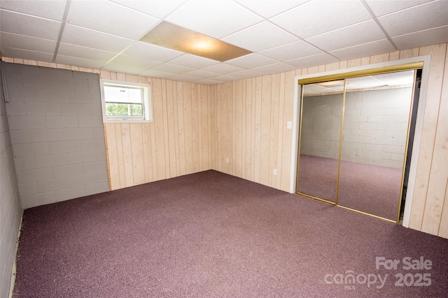 224 Mountain View Rd, Statesville, NC 28625 - unfurnished bedroom with dark colored carpet, a paneled ceiling, a closet, and wood walls
