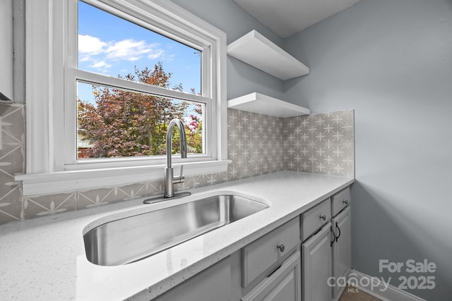 3422 Dublin Rd, Charlotte, NC 28208 - kitchen with open shelves, tasteful backsplash, and light stone countertops