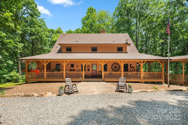 492 Henry Mountain Rd, Brevard, NC 28712 - back of property featuring roof with shingles, a chimney, and covered porch