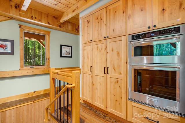 492 Henry Mountain Rd, Brevard, NC 28712 - kitchen with stainless steel double oven, light brown cabinetry, wood finished floors, and a wood ceiling with exposed beams