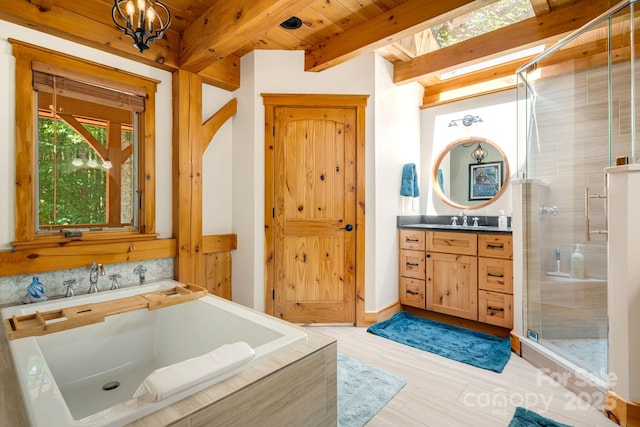 492 Henry Mountain Rd, Brevard, NC 28712 - bathroom with vanity, a shower stall, a chandelier, a garden tub, and wood finished floors