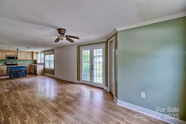 315 E Marion St, Kershaw, SC 29067 - unfurnished living room featuring crown molding, dark wood-type flooring, ceiling fan, and french doors