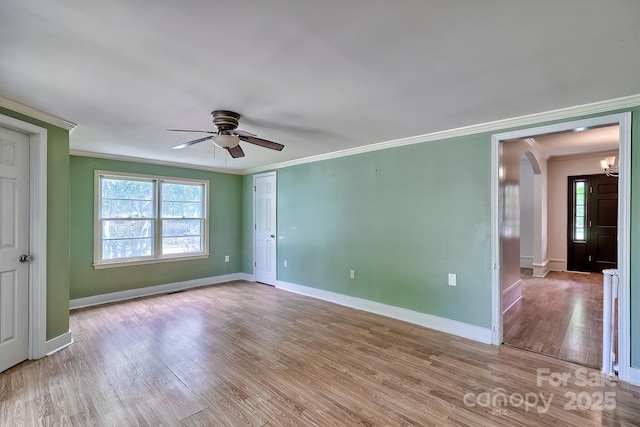 315 E Marion St, Kershaw, SC 29067 - spare room with crown molding, arched walkways, a ceiling fan, and wood finished floors