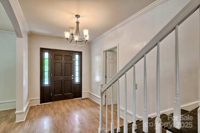 315 E Marion St, Kershaw, SC 29067 - foyer featuring light wood-style floors, crown molding, stairway, arched walkways, and a chandelier