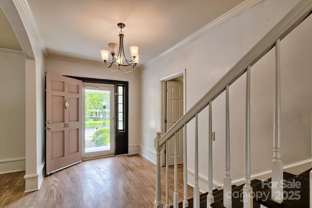 315 E Marion St, Kershaw, SC 29067 - entrance foyer featuring ornamental molding, wood finished floors, stairway, arched walkways, and a chandelier