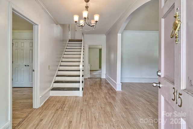 315 E Marion St, Kershaw, SC 29067 - entryway featuring crown molding, arched walkways, stairway, a chandelier, and light wood-type flooring