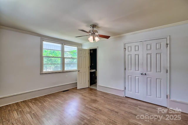 315 E Marion St, Kershaw, SC 29067 - unfurnished bedroom with ornamental molding, light wood-style floors, a closet, and ceiling fan