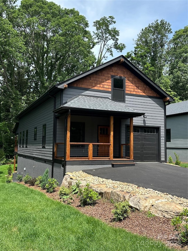 2031 S Oconeechee Ave, Black Mountain, NC 28711 - view of front of house with covered porch, asphalt driveway, and a front yard