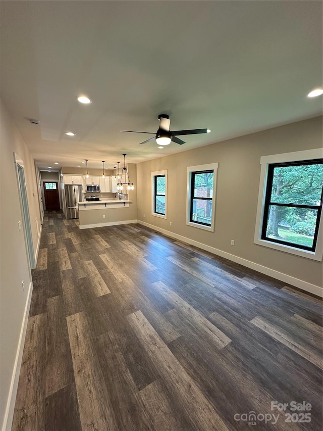 2031 S Oconeechee Ave, Black Mountain, NC 28711 - unfurnished living room with dark wood-style flooring, recessed lighting, ceiling fan, and a chandelier