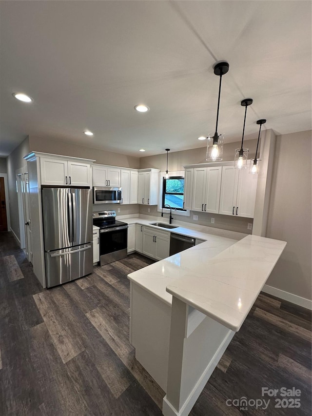 2031 S Oconeechee Ave, Black Mountain, NC 28711 - kitchen featuring stainless steel appliances, a peninsula, dark wood-style floors, white cabinets, and recessed lighting