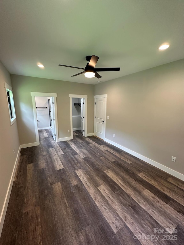 2031 S Oconeechee Ave, Black Mountain, NC 28711 - unfurnished bedroom with dark wood finished floors, recessed lighting, a spacious closet, and a ceiling fan