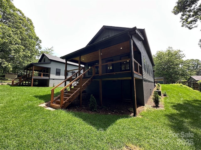 2031 S Oconeechee Ave, Black Mountain, NC 28711 - rear view of house with stairs, a yard, board and batten siding, and a deck