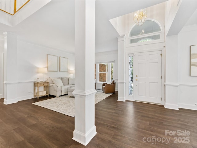 10527 Breamore Dr, Charlotte, NC 28270 - entryway featuring a towering ceiling, decorative columns, dark wood-style flooring, and a chandelier