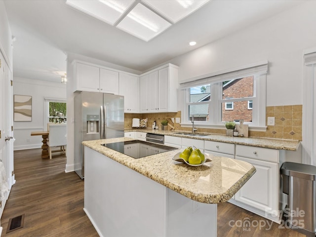 10527 Breamore Dr, Charlotte, NC 28270 - kitchen featuring stainless steel appliances, white cabinetry, a kitchen island, tasteful backsplash, and recessed lighting