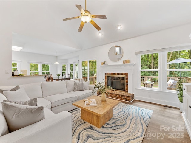 10527 Breamore Dr, Charlotte, NC 28270 - living area with wood finished floors, a ceiling fan, a fireplace, recessed lighting, and high vaulted ceiling