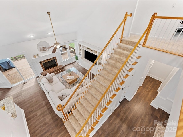 10527 Breamore Dr, Charlotte, NC 28270 - living room featuring a brick fireplace, a ceiling fan, wood finished floors, recessed lighting, and stairs