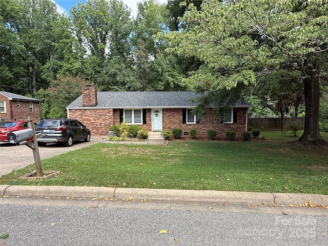 804 Lee St, Kings Mountain, NC 28086 - ranch-style house with brick siding, a chimney, a shingled roof, and driveway