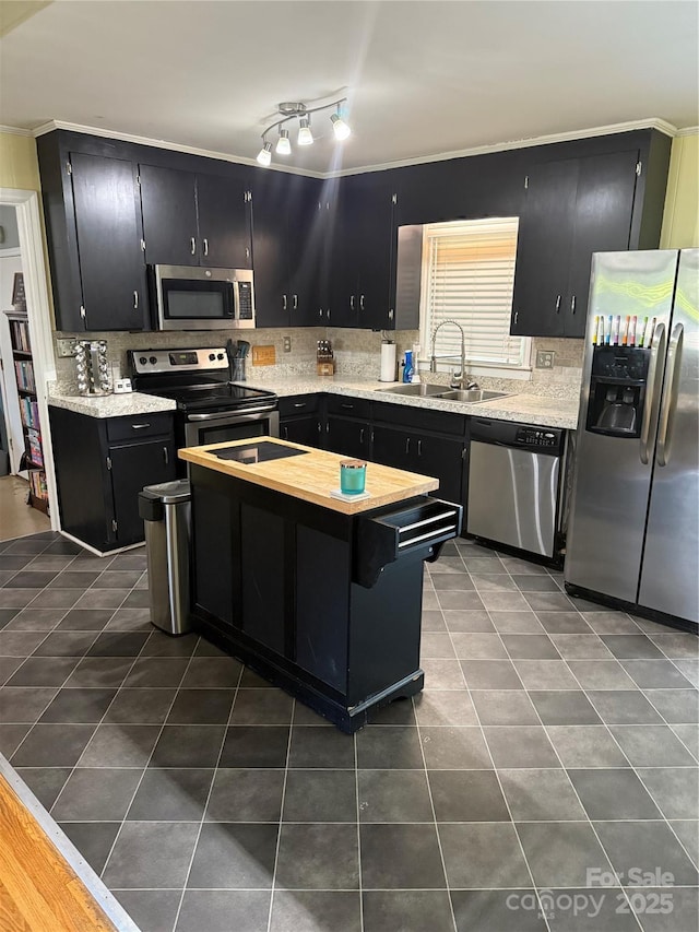 804 Lee St, Kings Mountain, NC 28086 - kitchen featuring stainless steel appliances, dark cabinetry, a center island, tasteful backsplash, and dark tile patterned floors