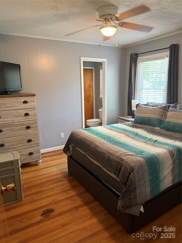 804 Lee St, Kings Mountain, NC 28086 - bedroom with a textured ceiling, light wood finished floors, ornamental molding, ensuite bath, and ceiling fan
