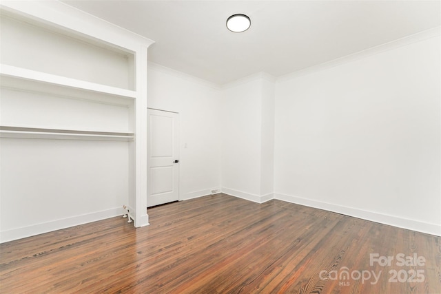 617 N Juniper Ave, Kannapolis, NC 28081 - unfurnished bedroom with dark wood-type flooring, crown molding, and a closet