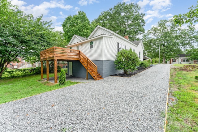617 N Juniper Ave, Kannapolis, NC 28081 - view of front of house with stairway, a wooden deck, a chimney, a front yard, and driveway
