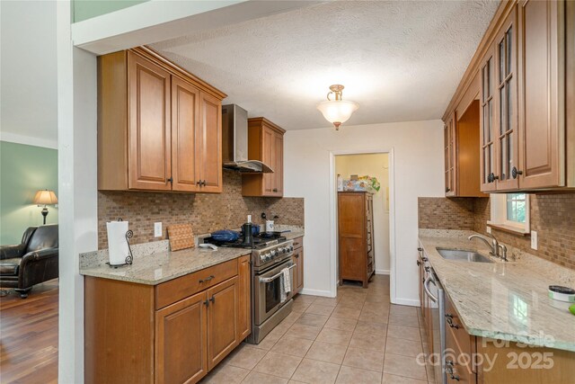 18 Peaceful Valley Ln, Flat Rock, NC 28731 - kitchen featuring appliances with stainless steel finishes, wall chimney range hood, backsplash, and glass insert cabinets
