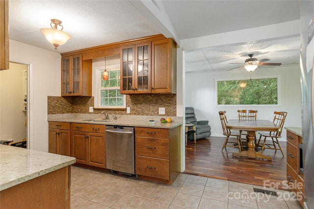18 Peaceful Valley Ln, Flat Rock, NC 28731 - kitchen with dishwasher, brown cabinetry, plenty of natural light, and backsplash