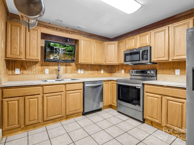291 Pine Ridge Rd, Hendersonville, NC 28792 - kitchen with appliances with stainless steel finishes, light countertops, light tile patterned floors, a textured ceiling, and wooden walls