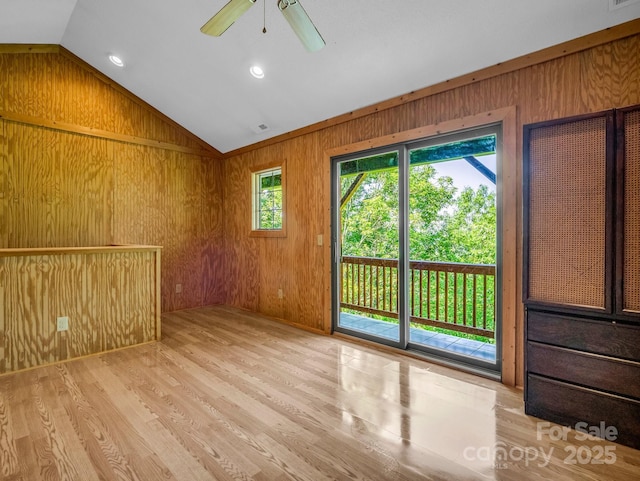 291 Pine Ridge Rd, Hendersonville, NC 28792 - unfurnished room with vaulted ceiling, wooden walls, light wood-style flooring, and ceiling fan