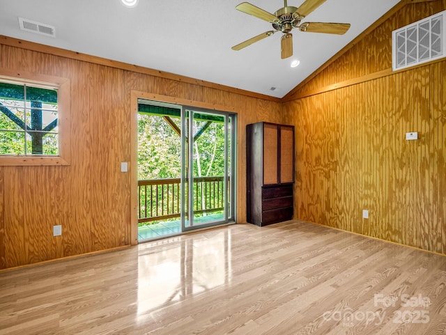 291 Pine Ridge Rd, Hendersonville, NC 28792 - spare room with lofted ceiling, wood walls, wood finished floors, and ceiling fan