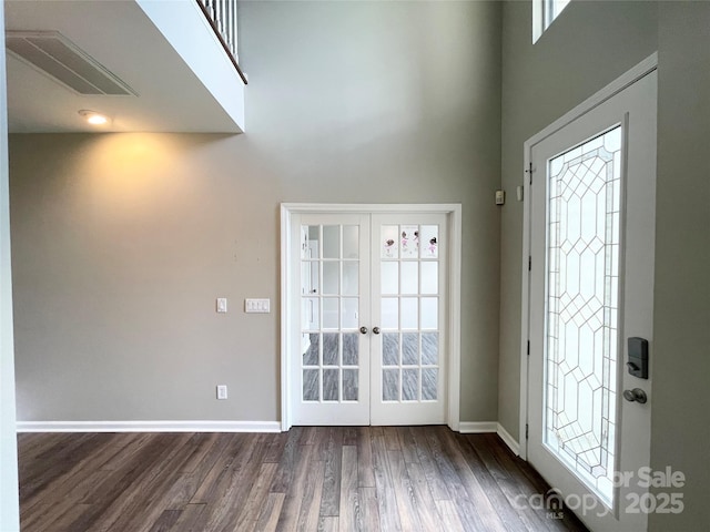 2834 Ritz Ln, Matthews, NC 28105 - foyer entrance featuring dark wood-style flooring, a towering ceiling, french doors, and plenty of natural light