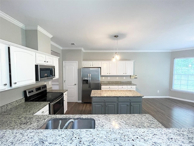 2834 Ritz Ln, Matthews, NC 28105 - kitchen featuring appliances with stainless steel finishes, dark wood-style floors, white cabinets, crown molding, and light stone countertops