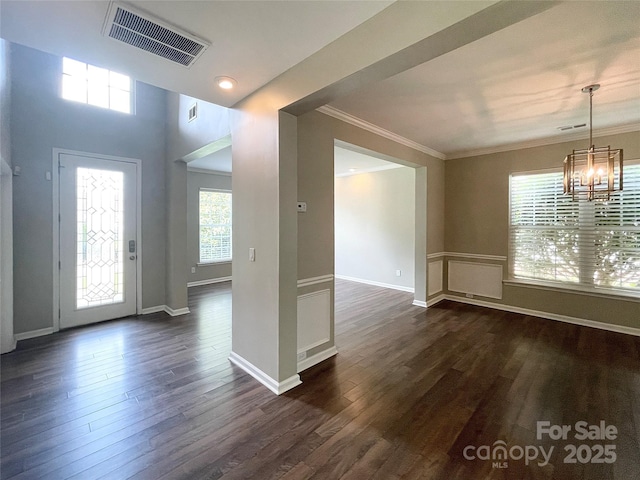 2834 Ritz Ln, Matthews, NC 28105 - entrance foyer featuring a chandelier, dark wood-style floors, and ornamental molding