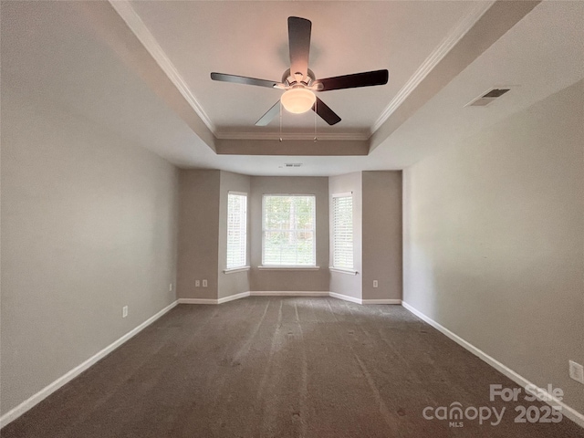 2834 Ritz Ln, Matthews, NC 28105 - spare room featuring a tray ceiling, ornamental molding, dark carpet, and a ceiling fan
