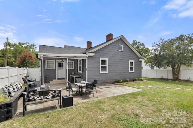 305 E Marion St, Kershaw, SC 29067 - back of property featuring a chimney, a fenced backyard, a patio, and outdoor lounge area