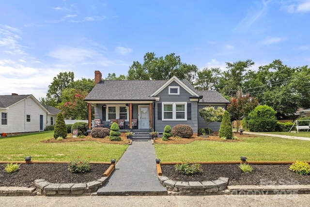 305 E Marion St, Kershaw, SC 29067 - bungalow with a porch, a front lawn, and a chimney