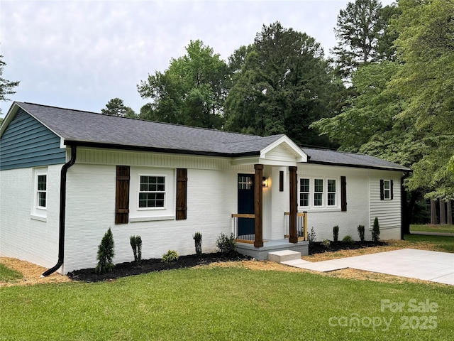 911 S Spencer Ave, Spencer, NC 28915 - ranch-style home featuring brick siding, a front lawn, and roof with shingles