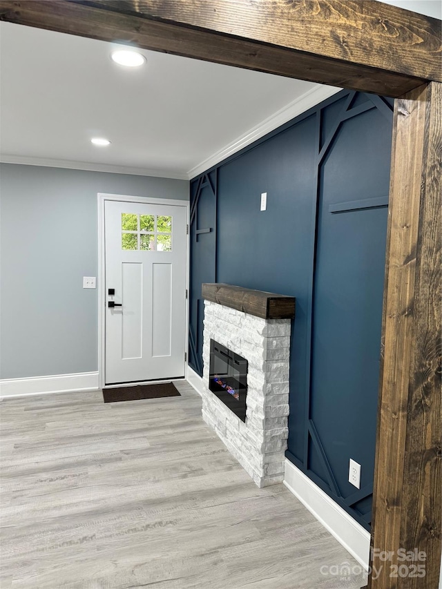 911 S Spencer Ave, Spencer, NC 28915 - entryway with light wood-type flooring, ornamental molding, a stone fireplace, and recessed lighting