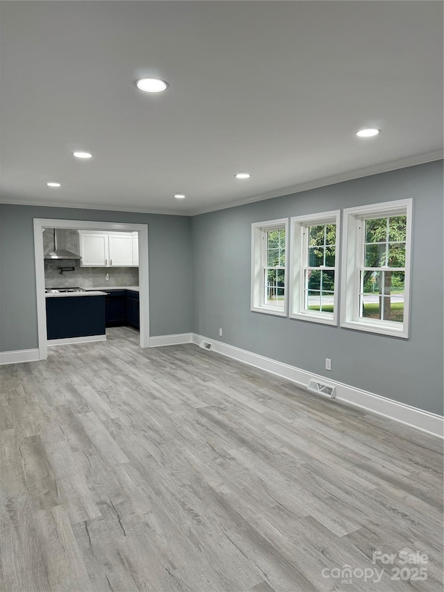911 S Spencer Ave, Spencer, NC 28915 - unfurnished living room featuring ornamental molding, recessed lighting, and light wood-style flooring