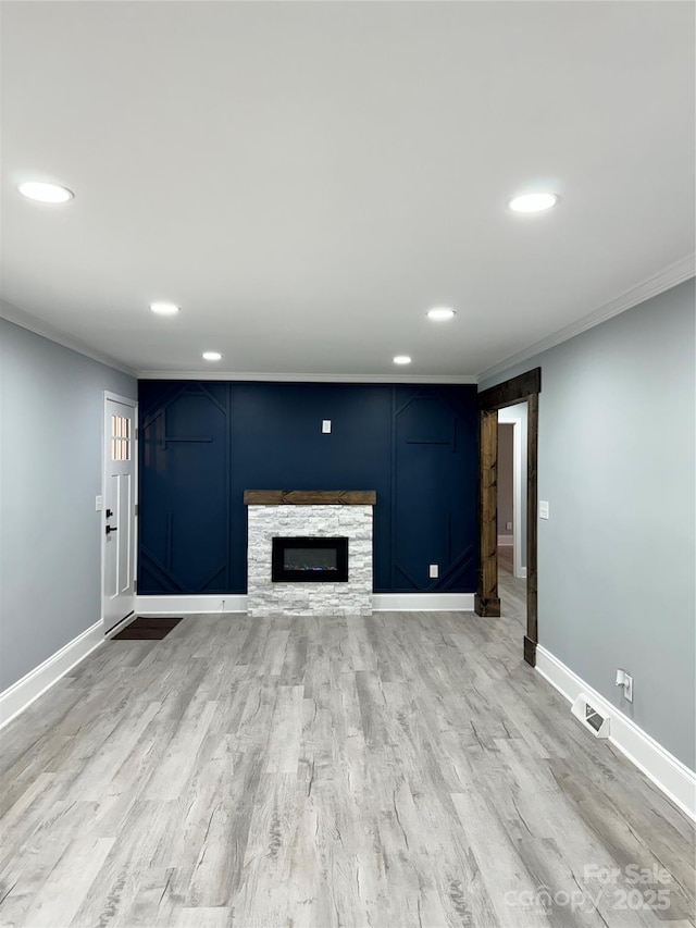 911 S Spencer Ave, Spencer, NC 28915 - unfurnished living room with recessed lighting, ornamental molding, a fireplace, and light wood finished floors