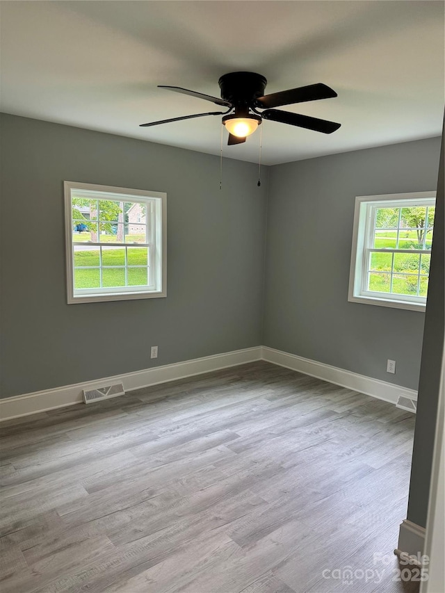 911 S Spencer Ave, Spencer, NC 28915 - spare room with healthy amount of natural light, wood finished floors, and a ceiling fan