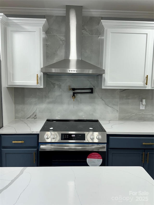 911 S Spencer Ave, Spencer, NC 28915 - kitchen with wall chimney exhaust hood, electric stove, white cabinets, and ornamental molding