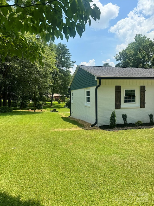 911 S Spencer Ave, Spencer, NC 28915 - view of property exterior featuring a lawn, brick siding, and a shingled roof