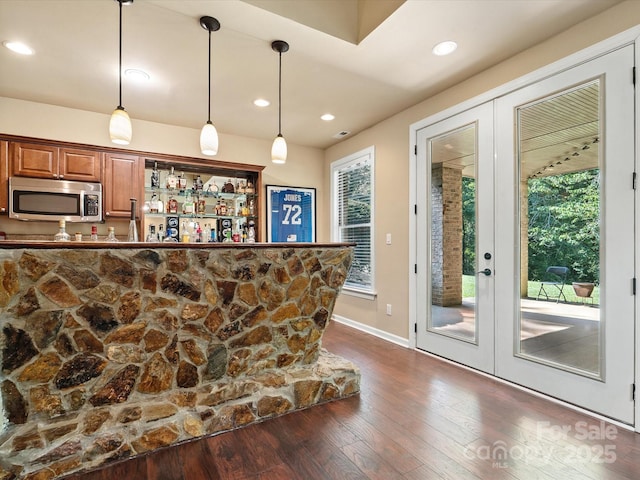 8407 Rolling Fields Rd, Mint Hill, NC 28227 - indoor dry bar with stainless steel microwave, french doors, dark wood-style flooring, decorative light fixtures, and recessed lighting