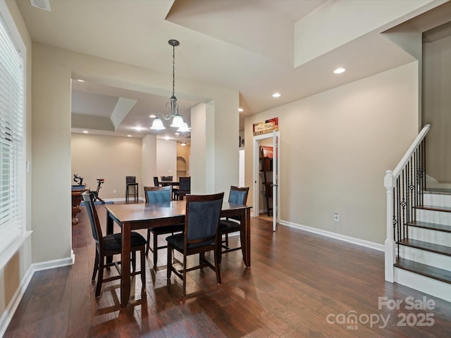 8407 Rolling Fields Rd, Mint Hill, NC 28227 - dining space with dark wood-type flooring, a raised ceiling, stairs, recessed lighting, and a chandelier